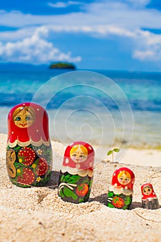 Photo Rows Puzzle Russian Dolls Matrioshka Souvenir Untouched Tropical Beach in Bali Island. Vertical Picture. Blurred