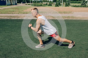 Photo of a running muscular sportsman on a stadium background. Full stadium plan