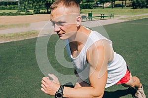 Photo of a running muscular sportsman on a stadium background. Full stadium plan