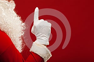 Photo of Santa Claus gloved hand in pointing