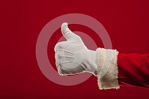 Photo of Santa Claus gloved hand in pointing gesture. fingers