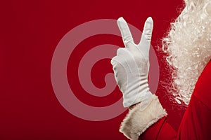 Photo of Santa Claus gloved hand in pointing gesture. fingers