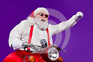 Photo of santa claus role man rapid riding newyear party by bike excited to see friends using super powers to move fast