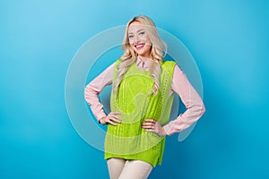 Photo of satisfied cheerful girl toothy smile put hands waist posing isolated on blue color background