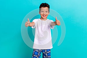 Photo of satisfied friendly boy wear trendy white clothes thumb up cool choice nice quality isolated on cyan color