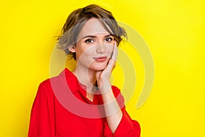 Photo of satisfied glad person arm touch cheekbone look camera isolated on yellow color background photo