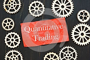 The photo says Quantitative Trading. Notepad, pen, marker