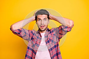 Photo of scared stunned man in stupor having no idea what to do with what he sees while isolated with yellow background