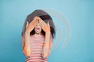 Photo of scared terrfied black woman covering her eyes after examination by oculist near empty space isolated over blue