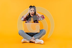 Photo of scared woman expressing shock while sitting on floor