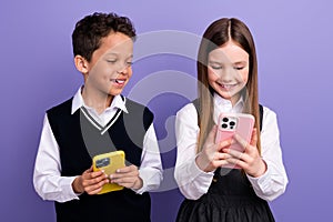 Photo of school kids using cell smart gadget watch learn video on youtube network isolated purple color background