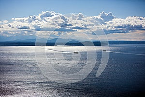 Photo of the sea with two ferries and an amazing clouds photo