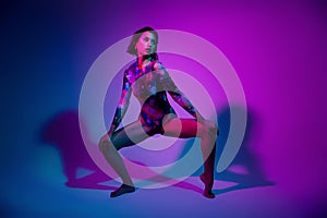 Photo of seductive cool woman dressed print bodysuit twerking empty space isolated violet color background photo