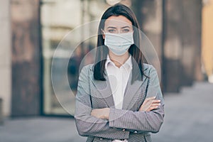 Photo of serious beautiful business lady crossed hands wear respiratory mask epidemic look job outside in city outdoors