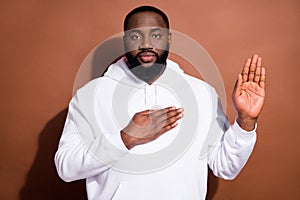 Photo of serious confident guy wear white hoodie listening anthem rising palm isolated brown color background