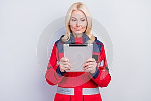 Photo of serious focused old professional paramedic woman look hold tablet worker isolated on grey color background