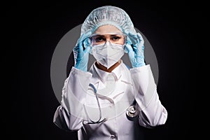 Photo of serious lady doc hold arms on protective plastic goggles ready prepare operation wear gloves mask coat facial