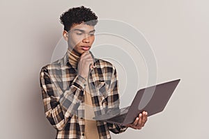 Photo of serious minded brunette afro american man think hold loo laptop work isolated on grey color background