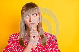 Photo of serious minded pensive woman hold finger chin look empty space isolated on shine yellow color background