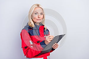 Photo of serious responsible old woman hold clipboard paramedic make list isolated on grey color background