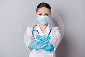 Photo of serious virologist doc lady experienced professional hold crossed palms infected zone wear gloves facial mask