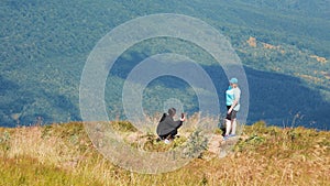 Photo session in the mountains. Tourists are photographed against the background of mountain landscapes. A person