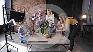 Photo session, photographers with professional cameras and mobile phone take pictures of still life in workshop on