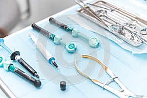 Photo of a set of steril dentistry tools or instruments lying on a table. photo