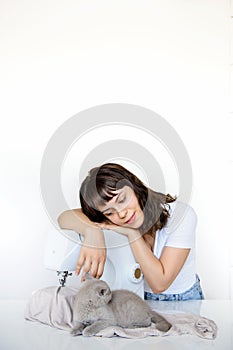 Photo of a sexy brunette working at the sewing machine