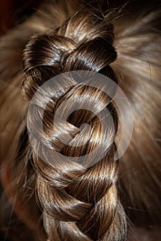 photo of shiny beautiful brown hair braided