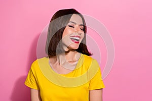 Photo of shiny funny young woman wear yellow outfit closed eyes laughing empty space smiling isolated pink color