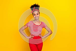 Photo of shiny positive girl dressed red striped t-shirt smiling hands arms waist isolated yellow color background