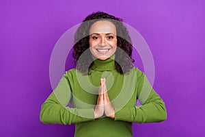 Photo of shiny sweet afro woman wear green turtleneck hands together asking you buy new clothes smiling isolated purple