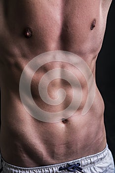 Photo of a shirtless muscular man