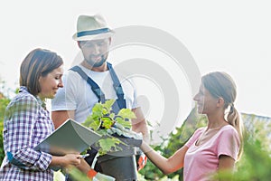 Photo of shop owner and garden staffs standing in the garden photo