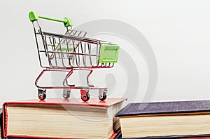 Photo of shopping cart standing on books