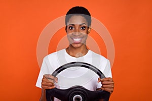 Photo of short hair androgyne lady driver hold auto steering wheel wear trendy t-shirt isolated vivid color background