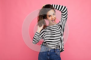 Photo shot of cute attractive pretty happy smiling amazing young brunette woman wearing casual striped longsleeve