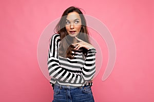 Photo shot of cute attractive pretty thoughful dreaming young brunette woman wearing casual striped longsleeve isolated