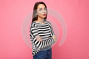 Photo shot of nice attractive pretty young sad upset sorrowful brunette woman wearing casual striped longsleeve isolated