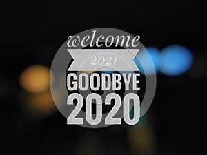 Photo show a text written WELCOME 2021 GOODBYE 2020 on the blurry background