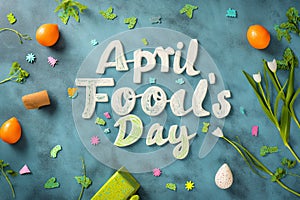 A photo showcasing a blue background with the bold words April Fools Day written across it