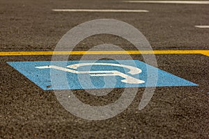 Photo showing the symbol of a disabled person placed on the parking lots intended for them.