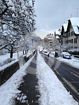 Kids tobogganing down a snow covered street photo