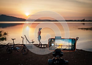 Photo silhouette scene sunset woman, her are activity enjoy relax and happy in vacation. Beautiful and romantic on holiday at lake