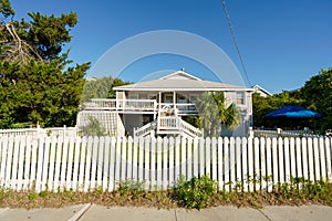 PHoto of a single family house with white picket fence in Wrightsville North Carolina close to the beach