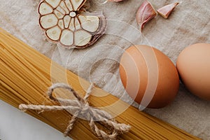 Photo of sliced garlic beside pasta