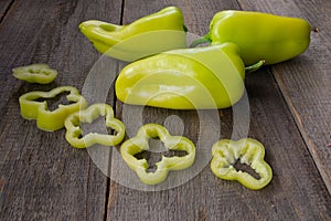 Photo of sliced green bell peppers over wooden table