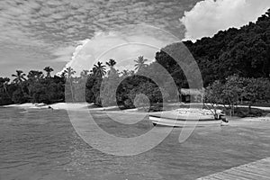 Photo of small fisherman boat moored near the boardwalk in the samana bay