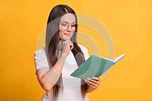 Photo of smart charming minded woman hold hand chin book novel isolated on shine yellow color background